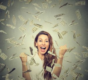 woman pumping fists celebrates success under money rain